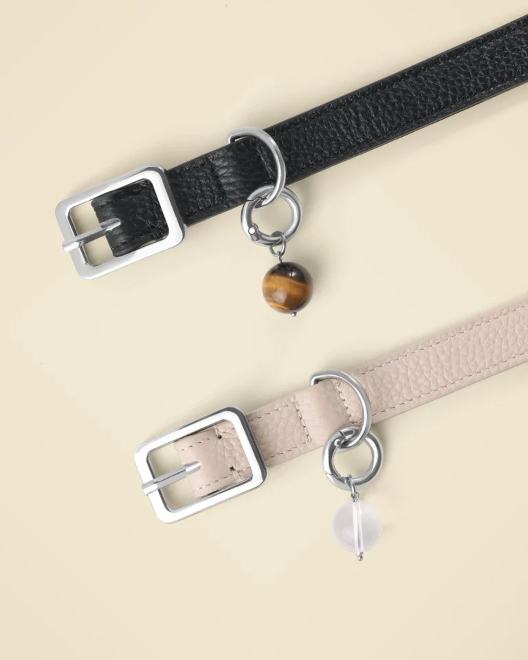 Black LuKra collar with a tiger's eye stone and taupe collar with a clear quartz stone