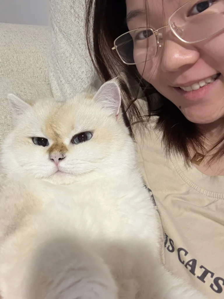 Cat owner bonding with her cat wearing an aquamarine collar