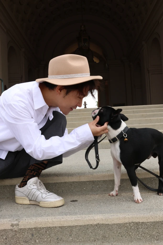 Fashion designer bonding with dog wearing gemstone collar
