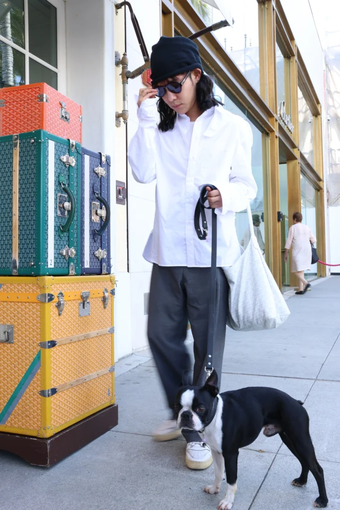 Fashion designer with dog wearing gemstone collar